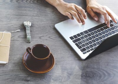 Female blogger writing on laptop